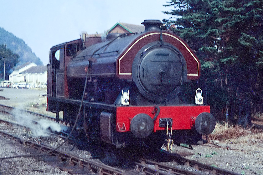 2294, taking water, Minehead Station 
 I belive that this is one of the WSR's Bagnall tanks 2294 'Vulcan'. It is seen from the platform at Minehead taking water. I am not sure why it was in-steam as the fire risk was extraordinary give that it was the middle of August in 1976. Three of these Bagnall tanks were built in Stafford in the 1950s for use in the South Wales steel works. After use, two made it into preservation and are still in-service today. 
 Keywords: 2294 Minehead Station