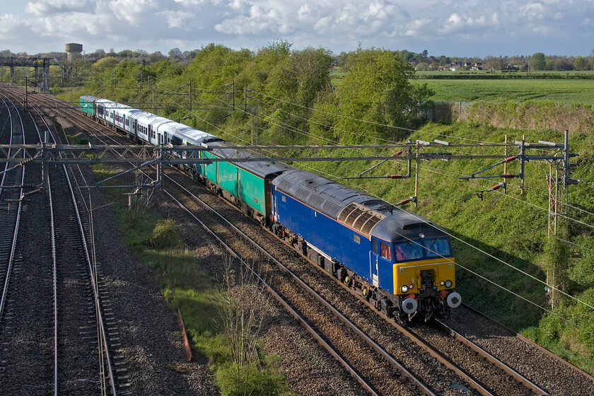 57303 & 458421, 13.11 Widness Transport Tech-Wembley Yard (5Q62, 11L), Victoria bridge 
 Former Virgin Thunderbird 57303 is now operated by, despite appearances, GBRf, and is now employed, among other things, undertaking drags. Having received attention (or conversion as it is being referred to!) at Alstom's Widness Technology Centre the locomotive tows South Western Railway's 458421 back to its third rail territory. The twenty-five million pound refurbishment of the 458s sees them reverting back to four-car sets and for use ostensibly on the London to Portsmouth route instead of the refurbished Class 442s; a plan that was quietly dropped that saw them unseremoniously scrapped. The two green barrier coaches are of interest being converted from former Class 508 EMUs. The leading one in this image is 64707 (formally from 508207) 'Laberzerin' now owned and operated by Arlington Fleet Services. I am not sure of the identity of the rear barrier unless anybody can identify it. After a layover in Wembley Yard, the 5Q62 then moved on and back to its Bournemouth base. 
 Keywords: 57303 458421 13.11 Widness Transport Tech-Wembley Yard 5Q62 Victoria bridge SWT South West Trains