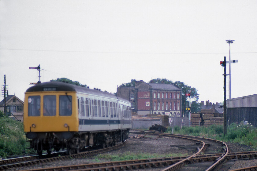 Class 114 DMU, 13.09 Cleethorpes-New Holland Pier, New Holland Town station 
 Despite the Class 114 DMU being out of focus, I have included this photograph due to other interesting things seen in it. To the rear left of the unit as it approaches New Holland Town station is Barrow Road Crossing signal box. The large building in the centre of the image is the former Yarborough Arms and hotel that was allegedly frequented by railway staff in times when many would have been working in the New Holland area. The DMU is taking the left-hand curve of a triangle of lines all of which can been also seen in the photograph. 
 Keywords: Class 114 DMU 15.09 Cleethorpes-New Holland Pier New Holland Town station first generation DMU