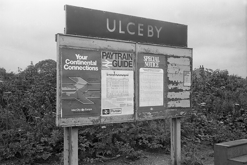 Enamel & notice board, Ulceby station 
 A period notice board at Ulceby station complete with s large blue enamel running in sign above. The posters include a full timetable (a 'Paytrain' guide as BR markets it) for the Cleethorpes to Newark route. The Special Notice to the right is the revised timetable for the New Holland and Barton-on-Humber branch that will follow the closure of the Humber ferry less than a week after this photograph was taken. The timetable revision includes the withdrawal of all services to and from New Holland Pier that was to close as part of the withdrawal of the ferry. Finally, the poster to the left was advertising rail links to Europe via ferries off course as this was still many years before the opening of the Channel Tunnel. 
 Keywords: Enamel notice board Ulceby station BR blue enamel