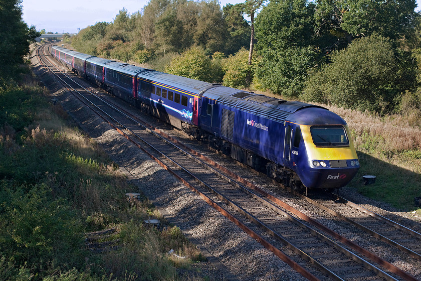 43018, GW 09.28 Swansea-London Paddington (via Gloucester) (1L51), Ashbury Crossing SU246878 
 Having travelled up the Severn Estuary via Lydney to Gloucester and then via the Golden Valley to Swindon, 43108 leads the diverted 09.28 Swansea to Paddington past Ashbury Crossing near Shrivenham. I love the dappled lighting in this picture This time of year creates a very special light that is warm and getting low but one that still has some strength in it. Notice the pilings ready to take the electrification masts that will totally obliterate this lovely view. 
 Keywords: 43018 09.28 Swansea-London Paddington via Gloucester 1L51 Ashbury Crossing SU246878