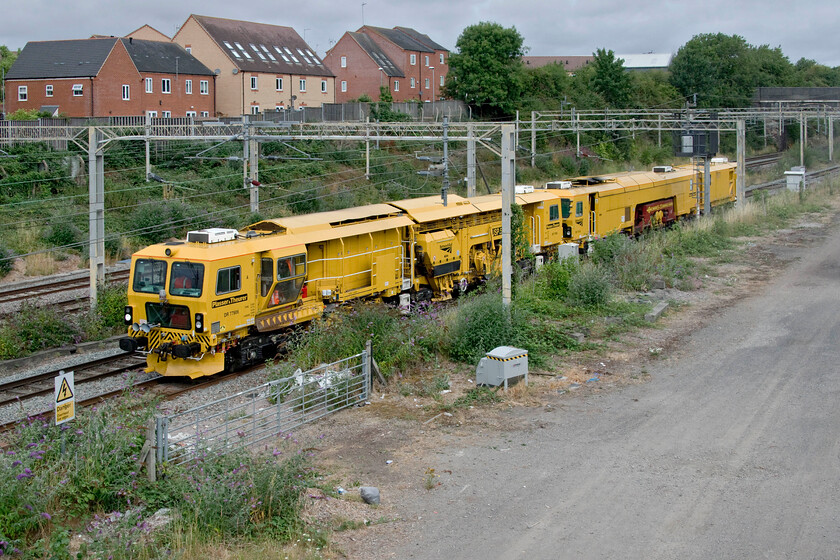 DR77906 & DR73116, 09.00 Rugby-Rugby (via Wembley), (6U44, 11L), site of Roade station 
 A strange out and back move that was all over in three hours passes the site of Roade's former station. The 6U44 09.00 Rugby to Rugby via quick reversal in Wembley Yard is composed of Network Rail's DR77906 and DR73116. Both units were manufactured by Plasser & Theurer for Network Rail around 2010 with the former being a ballast regulator and the latter a rail tamper. 
 Keywords: DR77906 DR73116, 09.00 Rugby-Rugby via Wembley 6U44 site of Roade station Plasser & Theurer USP5000RT Ballast Regulator network rail tamper Class ZWA-09-3X-D-RT