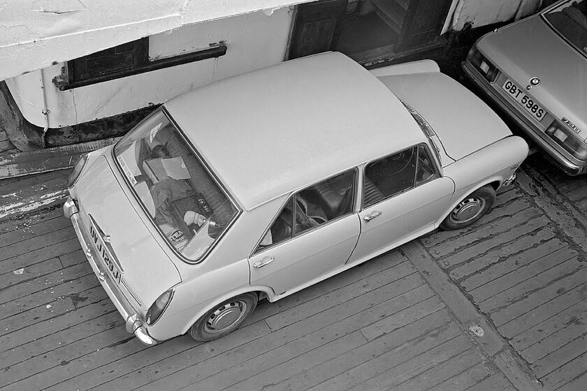 UVJ 129J, aboard MV Farringford, 16.50 New Holland Pier-Hull Corporation Pier 
 Graham's Austin 1100 UVJ 129J sits on the car deck of MV Farringfrod as it plies across the Humber estuary working the 16.50 New Holland Pier to Hull Corporation Pier. Notice the copy of Steam World magazine on the parcel shelf of the 1100 partially obscured by Graham's Sony TC-2890SD cassette recorder with its microphone sitting on top. The BMW 728 parked in front was one of the marque's most prestigious models on offer at this time but this particular example had the less powerful non-fuel injected M30 engine producing just 167bhp. This green example was registered in Leeds and was last on the road in 1986. 
 Keywords: UVJ 129J MV Farringford 16.50 New Holland Pier-Hull Corporation Pier Sealink Austin 1100