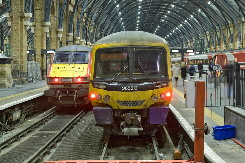 82219, GR 20.49 London King's Cross-Bounds Green TMD ECS (5Y46) & 365513, GE 20.44 London King's Cross-Ely (1T16), London King's Cross station 
 Taken on the platform end at King's Cross passengers are seen walking towards a VTEC service that will soon leave for Newcastle. Meanwhile, a Great Northern Networker will soon leave with the 20.44 to Peterborough. To the far left DVT 82219 brings up the rear of the 20.49 empty coaching stock train to Bounds Green. 
 Keywords: 82219 20.49 London King's Cross-Bounds Green TMD ECS 5Y46 365513 20.44 London King's Cross-Ely 1T16 London King's Cross station DVT VTEC Virgin Trains East Coast