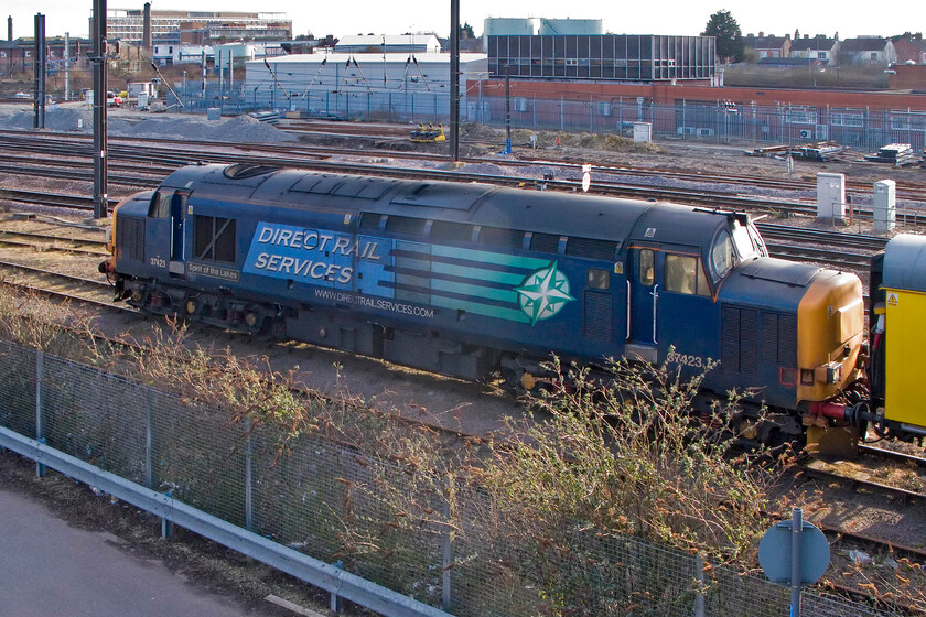 37423, NMR train, Peterborough North 
 On arrival back at Peterborough from Edinburgh, I left my wife and son at the station to go and collect the car from where I had parked it on Woodfield Road. On crossing the ECML to the north of the station the NMT was sitting under the bridge with 37423 'Spirit of The Lakes' leading the three yellow Mk. II coaches. Dominating the background is Peterborough PSB which opened in December 1972 wiping away several manual boxes in the process. However at now over forty years of operation time has been called with it due to be replaced by a huge regional signalling centre at York sometime in the next few years that is if Network Rail keeps up with its own schedule of works; something it is not very good at! 
 Keywords: 37423 NMR train Peterborough North Network Measurement Train DRS Direct Rail Services Spirit of The Lakes