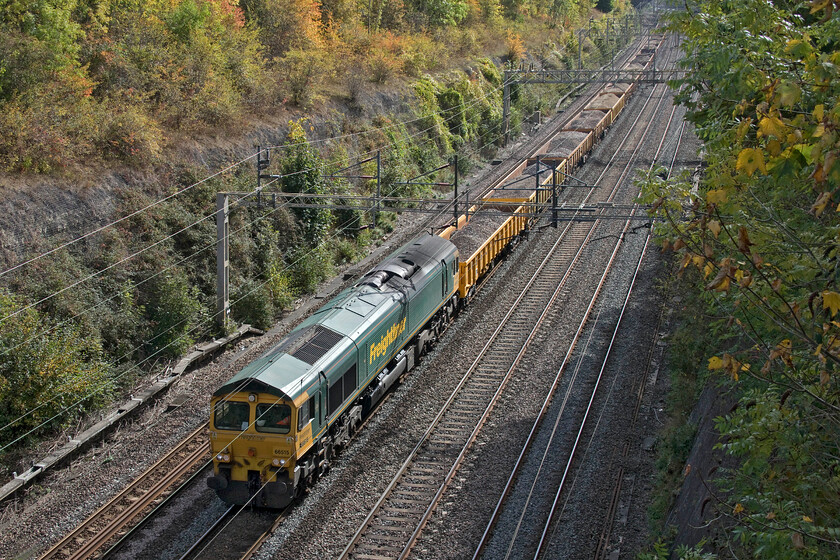 66515, 12.08 Denbigh Hall-Crewe Basford Hall (6Y70, 33L), Roade cutting 
 I had been observing 6Y70 sitting in the sidings at Bletchley (Denbigh Hall) wondering if it was going to actually run. Some time after its scheduled departure time, suddenly it was given a route out of the sidings, got a green light and was underway. 66515 is leading the infrastructure train that appeared to be returning used ballast to Crewe Basford Hall that was probably removed from various trackwork observed taking place in and around Bletchley's old depot. 
 Keywords: 66515 12.08 Denbigh Hall-Crewe Basford Hall 6Y70 Roade cutting Freightliner