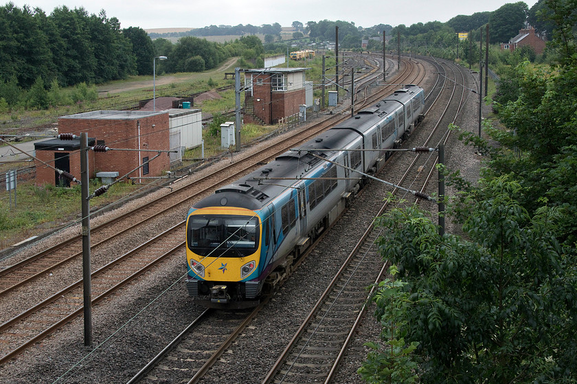 Class 185, TP 11.17 Newcastle-Manchester Airport (1P24, 4L), Ferryhill yard 
 An unidentified TPE class 185 heads south past Ferryhill working the 11.17 Newcastle to Manchester Airport. There was once a huge and strategically important marshaling yard on the land behind the signal box. This yard handled huge amounts of coal traffic from the pits on the northeast and Durham coalfields but as they closed, the yard has gone into terminal decline. Now, it is a mass a wasteland with just a few sidings where track machines appear to be stabled. 
 Keywords: Class 185 11.17 Newcastle-Manchester Airport 1P24 Ferryhill yard