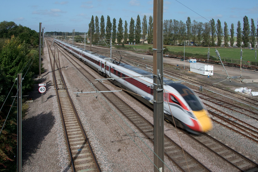 801215, GR 06.48 Glasgow Central-London King's Cross (1E06, RT), Tallington 
 Deliberately utilising a slower shutter speed, in this case, 1/100 sec. 801215 emphasises its speed with a significant amount of motion blur. This is further enhanced by the solid stability of the upright steel electrification mast placed in front of it. I like the image anyway! The LNER Azuma is seen passing Tallington working the 1E06 06.48 Glasgow Central to London King's Cross service. 
 Keywords: 801215 06.48 Glasgow Central-London King's Cross 1E06 Tallington LNER Azuma