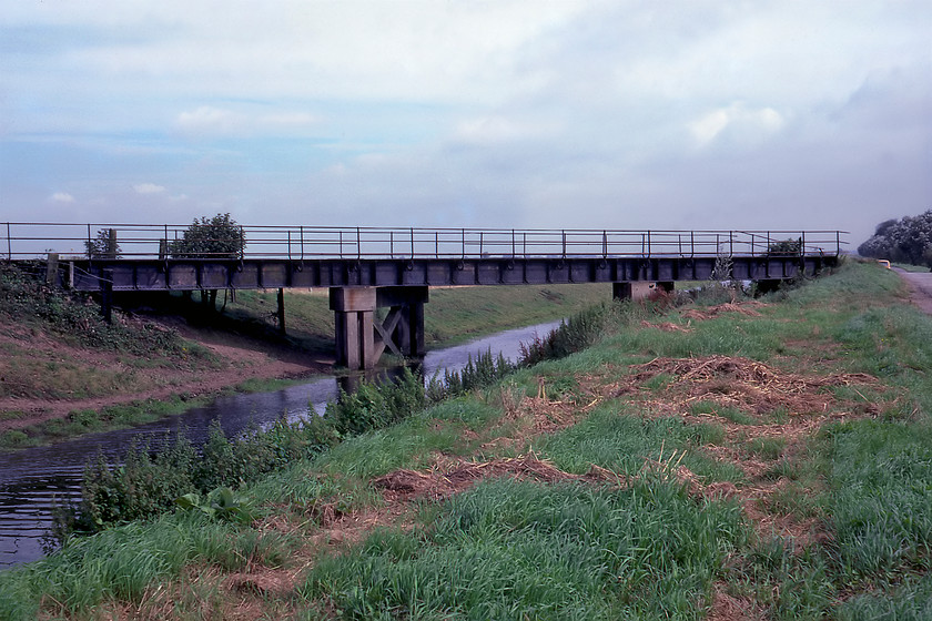 Former M&GN bridge, Counter Drain TF178208 
 The Midland & Great Northern Railway (M&GN) had a network of lines all over East Anglia. Most of their lines were closed both before and as a result of the Beeching report with many of them passing through virtually empty countryside. A remnant of their infrastructure is seen crossing Counter Drain. This stretch of the M&GN ran between Spalding and Bourne. There was once a station of the same name at this location that closed in 1959 when passenger services were withdrawn along the whole line. Freight lingered on until 1964 when the last train will have traversed the bridge. A study of Google Earth's Street View reveals the bridge still standing with the former station building just across the road. Notice in this photograph 'UAM' the orange Mini parked up just beyond the bridge. 
 Keywords: Former M&GN bridge Counter Drain TF178208