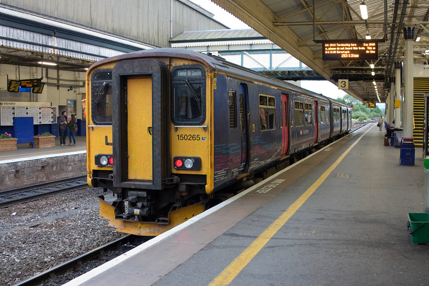 150265, GW 19.41 Exmouth-Exeter St. David's (2E52, RT), Exeter St. David's station 
 150265 has terminated at platform three of Exeter St. David's having arrived with the 19.41 from Exmouth. Even through it was one day off the longest day, the light was pretty grim by now. I was using a slow shutter speed in order to try and keep the ISO as low as possible so as to combat digital noise. 
 Keywords: 150265 2E52 Exeter St. Davids station