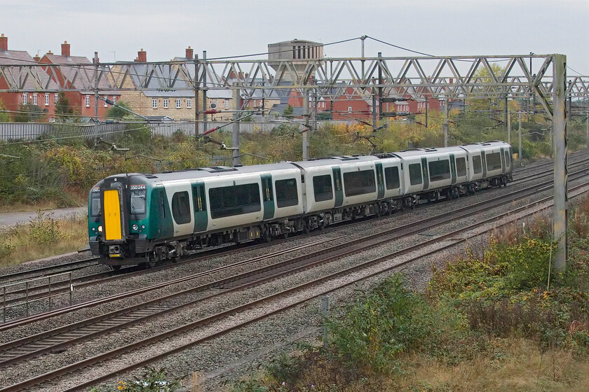 350244, 10.05 Wolverton Centre Sidings-Ardwick TMD (5Z77, 1E), site of Roade station 
 At first glance, this would appear to be a routine photograph of a London Northwestern Desiro passing Roade. However, close examination reveals that 350244 is devoid of any graphics. This is one of the first four members of the 350/2 subset that have come off-lease to head off to other areas. Initially, on Thursday 244 would join 350236 that was already at Wolverton with, 350251 and 350255 joining later. The units are debranded and then being sent north for possible use with Northern. Having just left Wolverton, the unit worked as 5Z77 arriving at Ardwick (Manchester) at 12.43. Incidentally, maybe taking all four off-lease at one go was a trifle premature as on Friday 350236 was back in service with London Northwestern! 
 Keywords: 350244 10.05 Wolverton Centre Sidings-Ardwick TMD 5Z77 site of Roade station London Northwestern Desiro