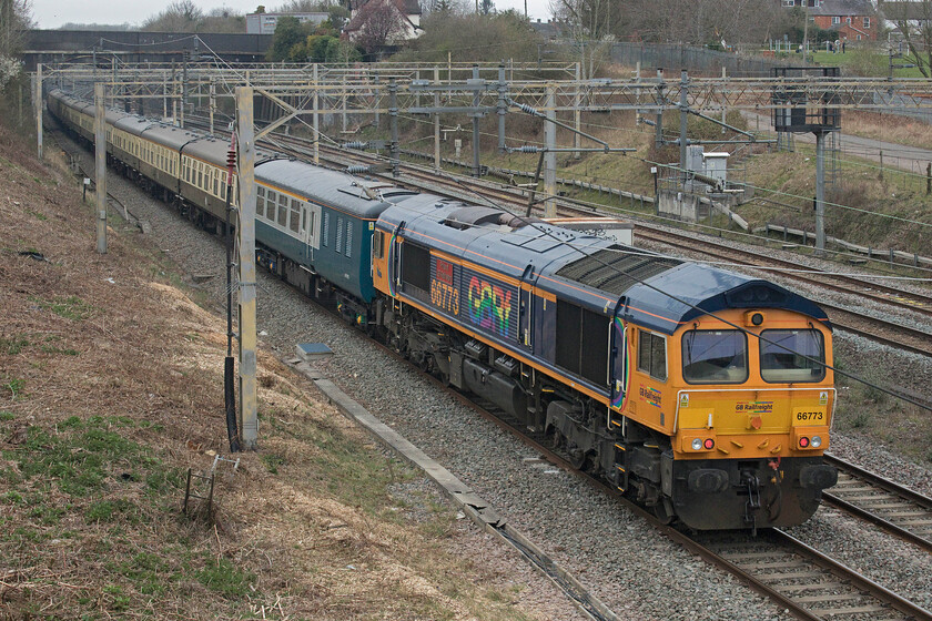 66773, 11.27 Wembley Reception sidings-Burton Ot Wetmore sidings (5Z50, 54L), site of Roade station 
 66773 'Pride of GB Railfreight brings up the rear of the late-running 11.27 Wembley Yard to Burton Ot Wetmore empty coaching stock move past Roade. The stock was used the previous day on the Springtime Hoovering in Devon charter hauled by 50007 (running as 50034) and 50049 with both these locomotives now leading this ECS, see.... https://www.ontheupfast.com/p/21936chg/30025173679/x50034-50049-11-27-wembley-reception. After arrival at Water Orton the Class 66 would then lead the train in the reverse direction to its destination near Burton-on-Trent with the Class 50s then running light engine onwards to their base at the Severn Valley Railway. 
 Keywords: 66773 11.27 Wembley Reception sidings-Burton Ot Wetmore sidings 5Z50 site of Roade station Pride of GB Railfreight GBRf