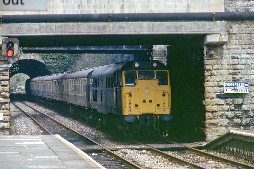 31123, unidentified Bristol Temple Meads working, Bradford-on-Avon station 
 31123 brings an unidentified working through Bradford-on-Avon station. It has just passed through the short tunnel and under the two bridges that carry Trowbridge and Frome Roads into the town from the west. I would be very interested to know what this train actually was as it is unusually long for this line, most were usually five-coach workings. Juts putting in an appearance to there left is Bradford's down starter, BJ102, that was actually a distant controlled by Bradford Junction signal box some three miles down the line towards Trowbridge. 
 Keywords: 31123 Bristol Temple Meads working Bradford-on-Avon station