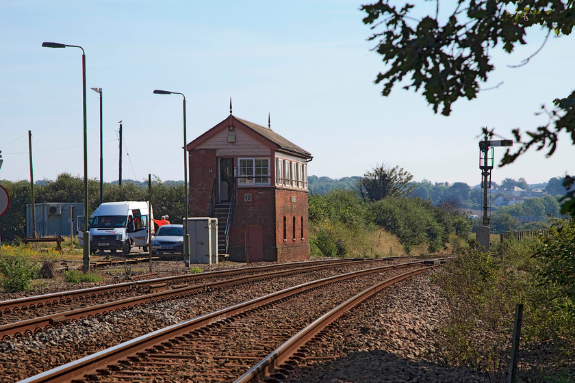 16. St. Erth Signal Box (GW, 1899) 
 St. Erth signal box is located some short distance east of the station with the main line passing in front and the St. Ives branch to the rear. For such a small village, the station has always been a pretty busy spot, more so in past years. There were once extensive sidings that were linked to the creamery that sent milk trains over night to London. The creamery closed in 1980, the sidings were lifted and the site became surplus. The site has been cleared in recent years and is now being developed for housing and a brand new car park for the station. 
 Keywords: St. Erth signal box GW 1899