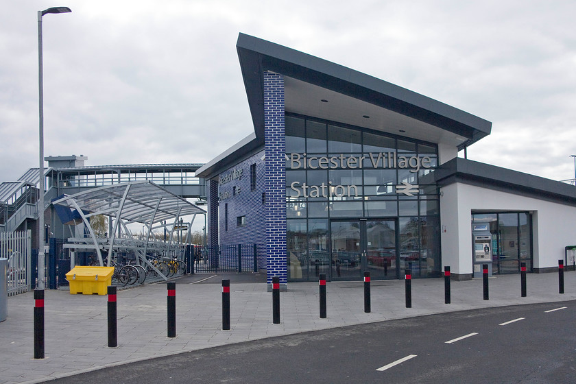 Frontage, Bicester Village station 
 The striking frontage of Bicester Village station that was reopened on 25th October last year (2015). Without local consultation, it was announced that it would be named Bicester Village in deference to the adjacent outlet village of the same name. It is likely that the numbers using the station will shoot through the roof now it has direct links to London and Oxford. 
 Keywords: Bicester Village station