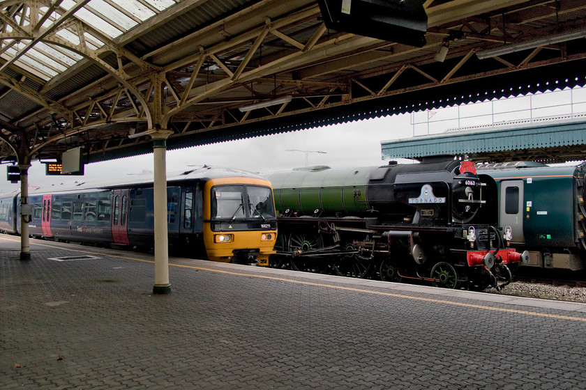 166211, GW 13.25 Bristol Parkway-Weston super Mare (2Y18, 12L), 60163, 13.50 Bristol East Depot, & 800317, GW 14.00 Bristol Temple Meads London-Paddington (1A20, 4E), Bristol Temple Mead station 
 An interesting trio of motive power at Bristol Temple Meads station. In the centre, is new build (now eleven years ago) Peppercorn Class A1 60163 'Tornado' passing through the station with a support coach as the 13.50 Bristol East Depot to Temple Meads positioning move. To its left, 166211 arrives with the 13.25 Bristol Parkway to Weston-super-Mare service. Finally, behind is the stock of 14.00 to Paddington formed by IET 800317. 
 Keywords: 166211 13.25 Bristol Parkway-Weston super Mare 2Y18 60163 13.50 Bristol East Depot 800317 14.00 Bristol Temple Meads London-Paddington 1A20 Bristol Temple Mead station Tornado IET Great Western Railway Turbo A1 Locomotive Trust