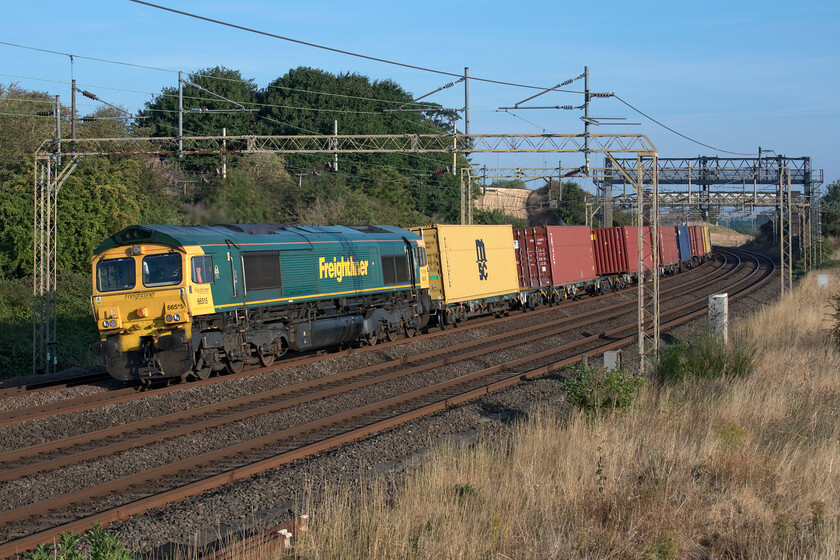 66515, 03.25 Garston-London Gateway (4L52, 8E), Old Linslade 
 We had been monitoring the progress of 4L52 as was heading southwards towards us on the up fast line half expecting it to go onto the slow at Hanslope Junction or perhaps at Drayton Road (Bletchley) but it remained on the fast past us here at Old Linslade to finally be moved over at Ledburn Junction with a number of faster services not up its backside! 66515 makes a fine sight leading the 03.25 Marston to London Gateway past Old Linslade on a stunning morning. 
 Keywords: 66515 03.25 Garston-London Gateway 4L52 Old Linslade Freightliner