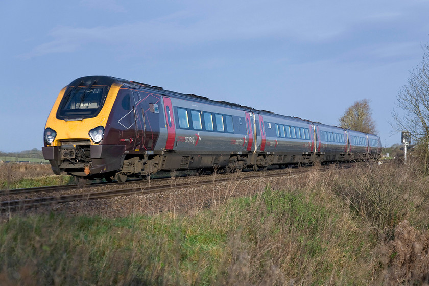 221135, XC 07.15 Southampton Central-Manchester Piccadilly (1M26), King's Sutton 
 The 1M26 07.15 Southampton to Manchester CrossCountry service goes away past me at King's Sutton. The train is being worked by 221135 one of the Voyagers that run with the tilting mechanism disabled. The photograph is taken from a former farmer's crossing that has recently been closed with the gates removed and fenced. 
 Keywords: 221135 07.15 Southampton Central-Manchester Piccadilly 1M26 King's Sutton