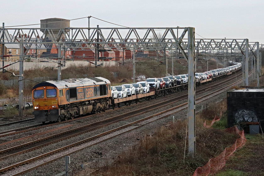 66752, 09.28 Dagenham Docks-Garston Car Terminal (6X43, 24E), site of Roade station 
 The first Ford car train of 2024 passes through Roade led by 66752 'The Hoosier State'. This train is usually bi-weekly with the empties returning as an evening working that can usually only be photographed during the longer summer days, see... https://www.ontheupfast.com/p/21936chg/30015904775/x88006-15-49-garston-dagenham-6l48 Conveying a wide variety of Ford products, all made on the continent but 'finished' on English soil, the 6X43 09.28 Dagenham Docks to Garston is seen passing Roade. Unfortunately, the bright start to the morning appears to be fading with a veil of grey cloud now enveloping the sky with the weather reverting to type! 
 Keywords: 66752 09.28 Dagenham Docks-Garston Car Terminal 6X43 site of Roade station Ford Hoosier State