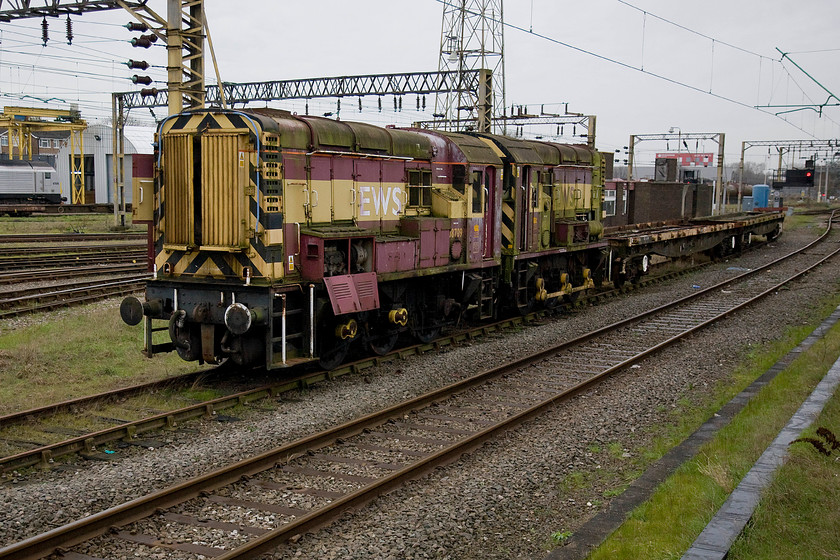 08709 & 08580, stored, Bescot Yard 
 Two very sad looking shunters sit stored and out of use in Bescot yard directly behind the station. 08709 is a 1960 built machine that was withdrawn in 2011. It is clear to see that its coupling rods have been removed either for use on another shunter or perhaps for ease of movement. Behind it is 08580, also withdrawn in 2011 but a slightly earlier build, 1959. 
 Keywords: 08709 08580 stored Bescot Yard