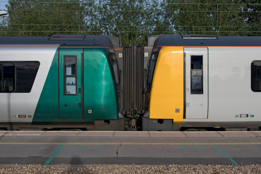 73720 (350110) & 63732 (350122), LN 07.07 Northampton-London Euston (2N02, 2L), Northampton station 
 Both of these Class 350s were from the original batch of thirty units that entered service during the summer of 2005 with Central Trains and Silverlink. In recent years their latest operator, London NorthWestern has embarked on a somewhat chaotic repainting of the sets but there appears to be no methodology as to how they are doing it! By way of example at Northampton, to the left car 73720 as part of set 350110 wears its rather lurid metallic green paint scheme whilst to the right 63732 as part of set 350122 wears plain off white paint very similar to when they were introduced into service sixteen years ago. 
 Keywords: 73720 350110 63732 350122 07.07 Northampton-London Euston 2N02 Northampton station London Northwestern Desiro