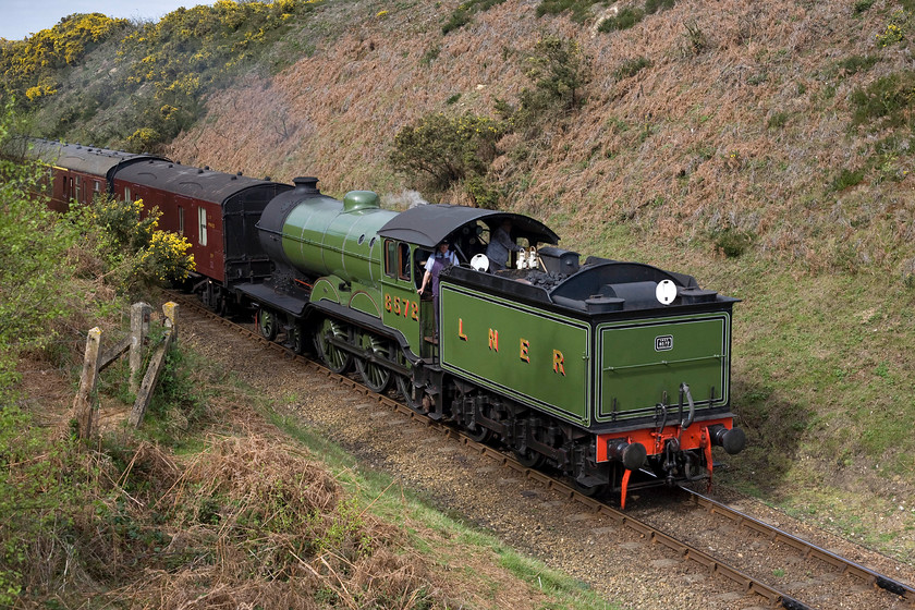 8572, 10.30 Holt-Sheringham, Kelling bank 
 With the driver and fireman keeping an eye on me the 10.30 Holt to Sheringham Poppy Line service passes as the train descends Kelling bank towards Weybourne. This view makes one realise how deep the cutting is at this spot and also makes me wonder where the Victorian navies took the spoil that was removed as there is no evidence of it adjacent to the line. 
 Keywords: 8572 10.30 Holt-Sheringham Kelling bank Poppy Line NNR North Norfolk Railway LNER B12 4-6-0