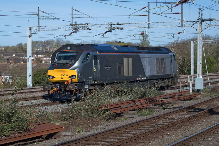 68010, 06.38 Crewe Gresty Bridge-Wembley Yard (0A68, 36L), Spenlows footbridge 
 The 0A68 06.38 (or thereabouts) Gresty Bridge to Wembley Yard light engine move is a regular Saturday morning turn that can sometimes produce a number of locomotives coupled together. They make their way back south after exams and maintenance at DRS' Gresty Bridge facility with a balancing working in the other direction later in the day. On this particular Saturday, I was grateful that it was just one locomotive in the form of 68010 'Oxford Flyer' as it fitted perfectly between the wiring posts at Spenlows bridge between Milton Keynes and Bletchley. 
 Keywords: 68010 06.38 Crewe Gresty Bridge-Wembley Yard 0A68 Spenlows footbridge Oxford Flyer