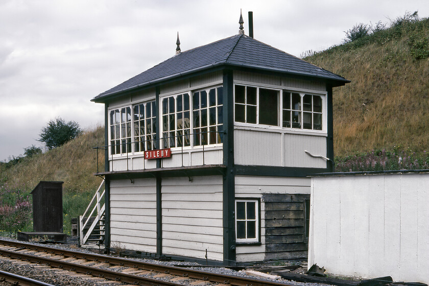 Sileby signal box (MR, 1887) 
 Before departing from the MML and heading east Graham and I went for just one more signal box at Sileby. Another example of putting myself in a position to take a photograph that is not now seen as being prudent and one that would never be considered today! I suspect that I was probably somewhere on the down slow line to capture this image of the 1887 Type 2b Midland box. I can find precious else about the box apart from its closure date being 11.04.87. Any further information would be appreciated. 
 Keywords: Sileby signal box MR Midland Railway