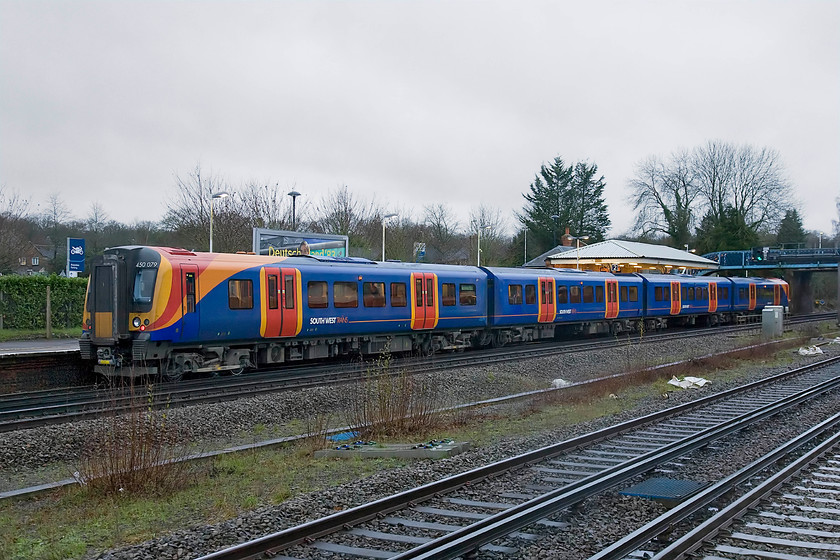 450079, SW 14.12 London Waterloo-Basingstoke (2L41), Hook station 
 South West Trains' 450079 pauses at Hook station working the 14.12 Waterloo to Basingstoke service. In common with many stations, whilst Fleet does retain one through-line, it has lost the down through line evidenced by the large gap in the centre of the photograph. 
 Keywords: 450079 SW 14.12 London Waterloo-Basingstoke 2L41 Hook station Desiro