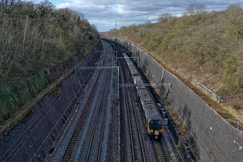 350250, 350262 & 350246, LN 15.55 Northampton-London Euston (2Z46, 3E), Roade cutting 
 The 15.55 Northampton to London Euston enters Roade cutting from the north formed by 350250, 350262 and 350256. Due to the Covid-19 restrictions, this is one of the services put in place by London Northwestern as part of their emergency timetable. It may be that after the situation is resolved that London Northwestern look at their wildly over-complicated timetable and take some lessons from what they are offering now? 
 Keywords: 350250 350262 350246 15.55 Northampton-London Euston 2Z46 Roade cutting