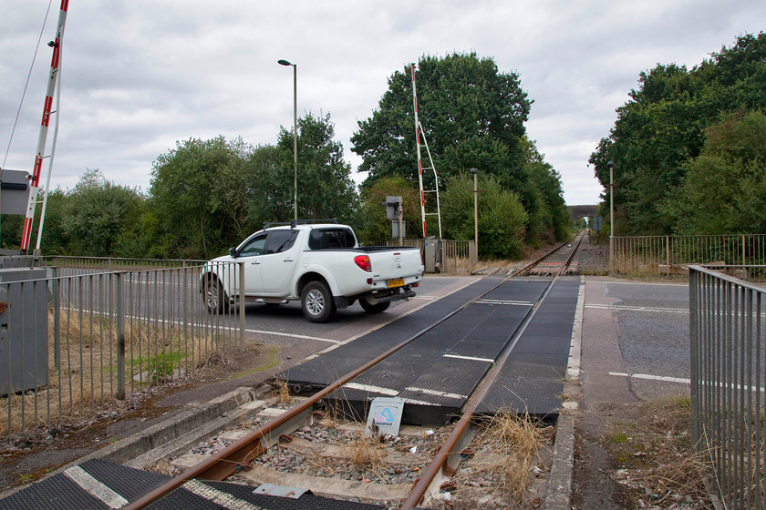 East-West line looking NE, Bicester Eastern Perimeter Road crossing 
 The barriers at Bicester's Eastern Perimeter road level crossing are not lowered very often but things are possibly going to change in the near future? That is if the fabled east-west rail link ever comes to fruition turning this rarely used line into a double track 100mph main line linking Oxford with Bedford and beyond. 
 Keywords: East-West line Bicester Eastern Perimeter Road crossing