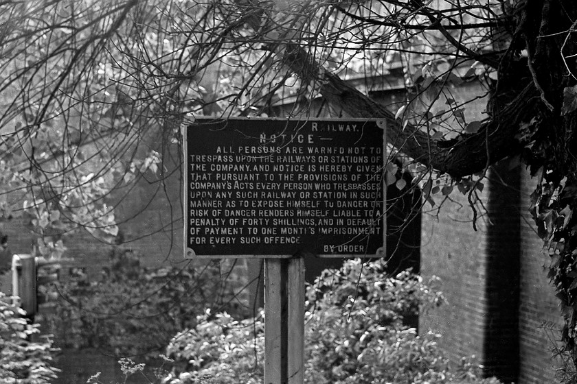 Ex GWR cast sign, Sydney Gardens 
 A former GWR cast sign in Bath's Sydney Gardens. In common with most of these signs, the Great Western part of the title has been painted over in black paint leaving the Railway word left, rather incongruously, to the extreme right. On reading the sign there appears to be a quite a mismatch between the fine of forty shillings and the one months imprisonment. Today, forty shillings would be about 2. 
 Keywords: GWR cast sign Sydney Gardens