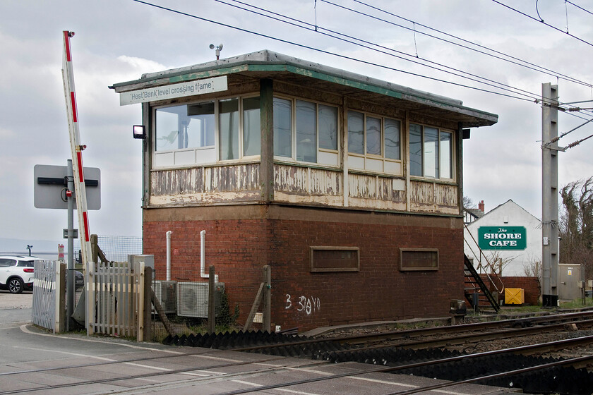 Hest Bank level crossing frame signal box (BR (LMR), 1958) 
 This is my third photograph of Hest Bank Level Crossing Ground Frame box which I first captured in 1985. Even back then the 1958 BR (LMR) structure looked tatty but had deteriorated more by 2013 when I last visited, also with Andy! As can be seen here, the woodwork cladding of the box now looks to be in very poor condition. Perhaps no money will be spent on the box as I suspect its role in controlling the level crossing is now very limited; advise anybody? 
 Keywords: Hest Bank level crossing frame signal box BR LMR 1958