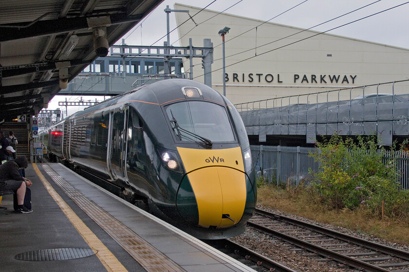 800020, GW 18.00 Stoke Gifford-Bristol Temple Meads (5E74, 4E), Bristol Parkway station 
 With the GWML closed east from Westerleigh Junction as far as Wootton Bassett there were no through services from Bristol Parkway to and from South Wales necessitating passengers having to go north to Gloucester. Those wishing to travel up to Paddington it was a little easier with them advised to head for Temple Meads. This GWR IET, 800020, was also heading to Temple Meads as the 5E74 empty stock move from Stoke Gifford that would then probably be heading to London carrying some of the displaced passengers. Parkway's iconic station building is seen in the background opened in 2000. 
 Keywords: 800020 18.00 Stoke Gifford-Bristol Temple Meads 5E74 Bristol Parkway station GWR IET