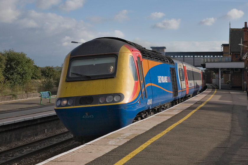 43043, EM 15.15 London St. Pancras-Nottingham (1D47), Wellingborough station 
 43043 sweeps around Wellingborugh's steeply cambered curve at line speed leading the 1D47 15.15 St. Pancras to Nottingham HST service. If I was commuting from London at about this time I would try hard to travel on one of the HST services rather than a Meridian. This power car was part of the first batch of HSTs to be delivered to the Western Region back in 1976 being nominally part of set 253021. This one is EMT's earliest and lowest numbered example that they operate. 
 Keywords: 43043 15.15 London St. Pancras-Nottingham 1D47 Wellingborough station EMT East Midlands Trains HST