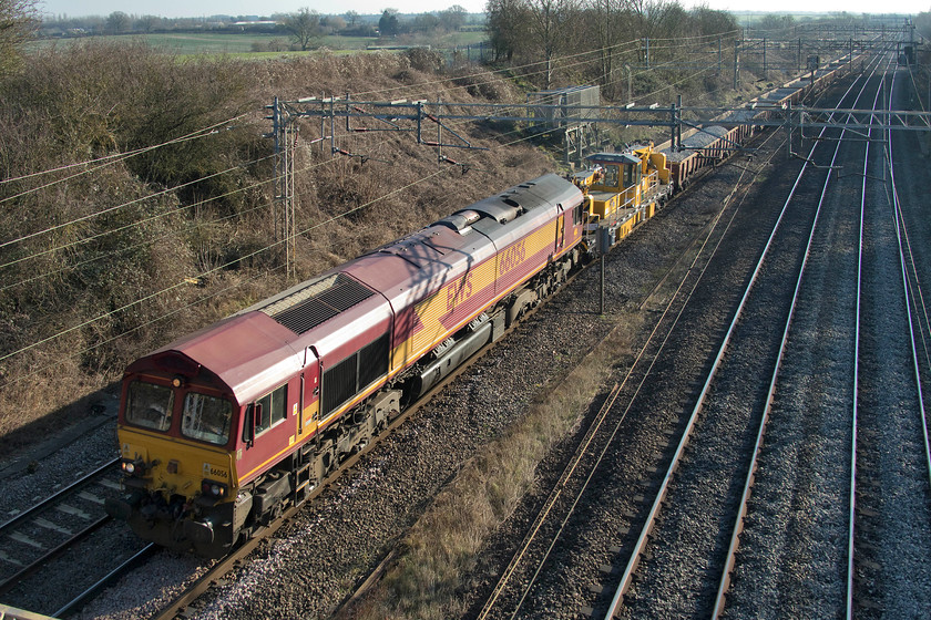 66056, 10.45 Weedon-Bescot (via Bletchley) (7R03), Victoria bridge 
 The first of three infrastructure trains to pass Victoria bridge between Roade and Ashton was the 7R03 10.45 Weedon to Bescot. This train had worked up to Bletchley earlier following overnight engineering works on the Weedon loop line. The 66 then ran round at Bletchely and is seen returning north, this time, via the Northampton. line. 
 Keywords: 66056 10.45 Weedon-Bescot via Bletchley 7R03 Victoria bridge