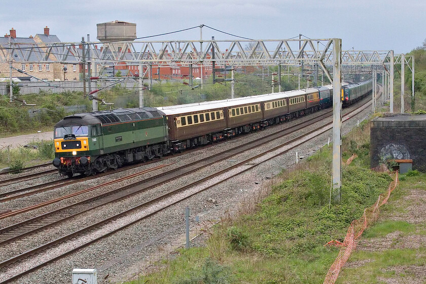 D1935, retrun leg of the Royal Windsor Statesman, 15.40 Windsor & Eaton-Crewe Riverside (1Z62, 2L), site of Roade station 
 Narrowly avoiding being bowled by a Class 350 heading south the returning Royal Windsor Statesman charter is seen passing Roade led by D1935 'Roger Hosking MA 1925-2013'. The charter left Windsor and Eaton Riverside station at 15.40 and was heading back to Crewe dropping customers off at various points between the two. Note the BR blue and grey Mk.1 catering vehicle marshalled in the centre of the train spoiling the look of the Statesman liveried Mk. II stock 
 Keywords: D1935 The Royal Windsor Statesman 15.40 Windsor & Eaton-Crewe Riverside 1Z62, 2L site of Roade station LSL Statesman 'Roger Hosking MA 1925-2013'