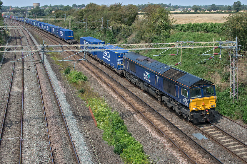 66432, 13.09 DIRFT-Ripple Lane (4L48, 6L), Victoria bridge 
 Operating as regular as clockwork, the 4L48 13.09 Daventry to Ripple Lane and thence to Tilbury passes Victoria bridge just south of the village of Roade. DRS' 66432 is leading the Tesco Express service that does an excellent job in keeping many lorries off the roads. 
 Keywords: 66432 13.09 DIRFT-Ripple Lane 4L48 Victoria bridge DRS Direct Rail Services Tesco Express