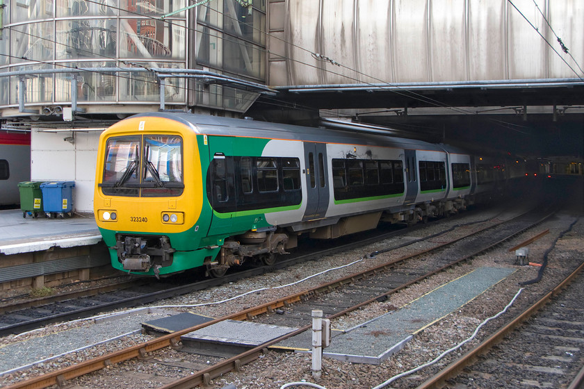 323240, LM 09.08 Birmingham New Street-Wolverhampton (2W12), Birmingham New Street station 
 323240 emerges from the gloom of Birmingham New Street working the 09.08 to Wolverhampton 'stopper' service. The soundtrack to this class of unit as they get underway or slow down is a distinctive rising or falling whine. This is made through 'multiple phases caused by use of a gate turn-off thyristor-based inverters as part of the traction control circuitry that drives the 3-phase AC motors' - apparently! This was a common setup in the early to mid-1990s and could be heard on a number of units from this era such as the networkers, see..... https://www.ontheupfast.com/v/photos/21936chg/23868581604/x466021-2d33-sittingbourne-station 
 Keywords: 323240 09.08 Birmingham New Street-Wolverhampton 2W12 Birmingham New Street station London Midland LM