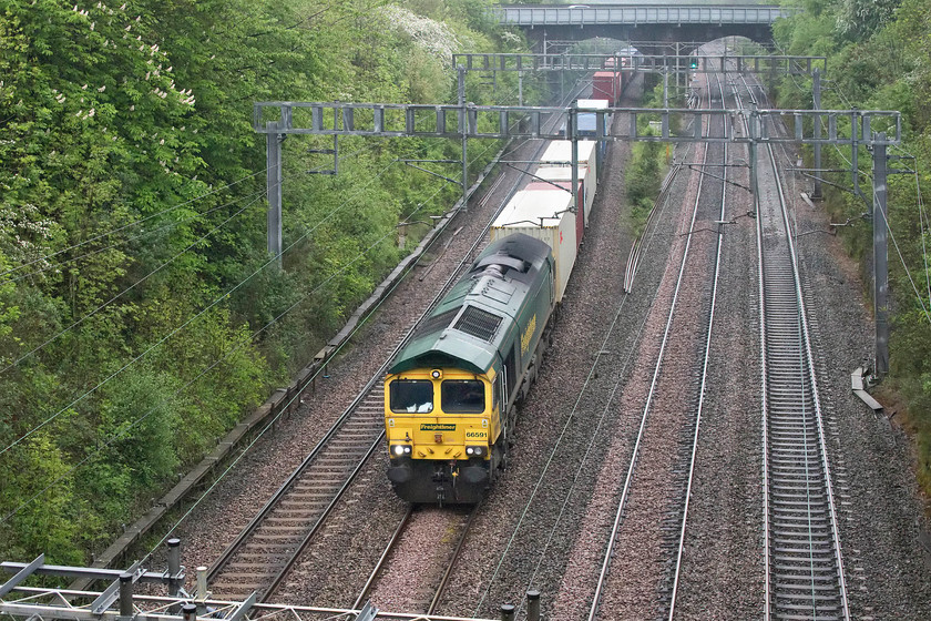 66591, 04.25 Felixstowe North-LawleyStreet (4M88), Hyde Road bridge 
 The 4M88 04.25 Felixstowe North to Lawley Street Freightliner enters Roade cutting taken from Hyde Road bridge in the village. This is a return working for this locomotive, the previous afternoon it was seen heading the opposite way with the 13.01 from Birch Coppice to Felixstowe. 
 Keywords: 66591 04.25 Felixstowe North-LawleyStreet 4M88 Hyde Road bridge