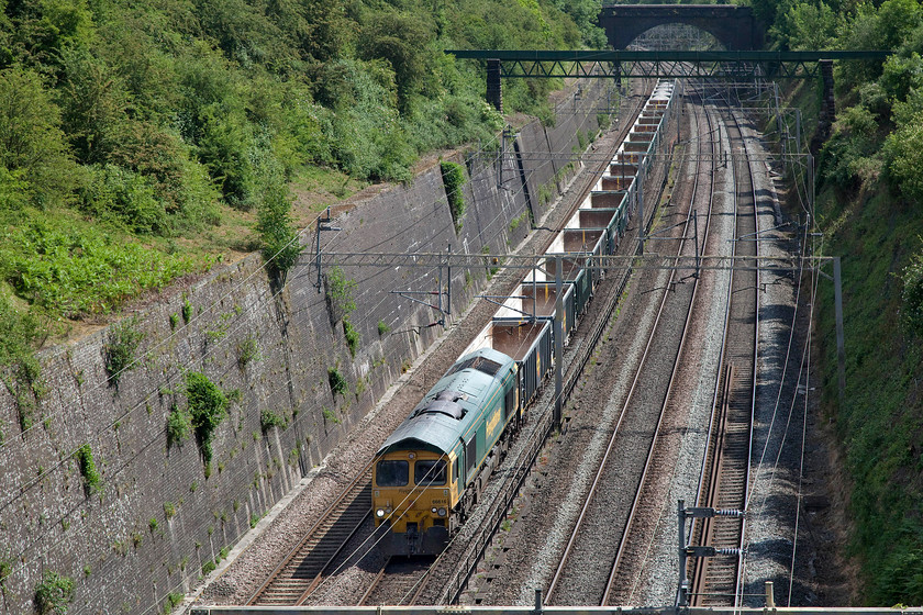 66616, 13.17 Willesden-Tunstead (6H50, 2E), Roade cutting 
 The 6H50 is one of those workings that appears regularly in the WTT but rarely actually runs. However, the 13.16 Willesden to Tunstead did run on this day with 66616 leading the train. It passes through Roade cutting with a largely empty set of JYA wagons apart from four that were mysteriously fully loaded at the rear. This particular Freightliner 66/6 is far better suited to this sort of working with its lower gearing and consequentially greater torque (tractive effort in railway parlance) but reduced speed - sixty-five as opposed to seventy-five miles per hour compared to a standard Class 66. Last week, this locomotive was seconded to an intermodal service due to a failure and is the only time that I can recall seeing a 66/6 working such a train, see..... https://www.ontheupfast.com/p/21936chg/29056406204/x66616-12-16-lawley-street-london 
 Keywords: 66616 13.17 Willesden-Tunstead 6H50 Roade cutting Freightliner