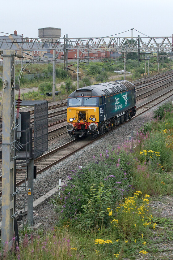 57309, 12.45 London Euston-Rugby (0Z05, 43E), site of Roade station 
 This light engine move was not scheduled to run on RTT appearing to have been added at the last minute. DRS' 57309 'Pride of Crewe' heads north along the down fast line passing the site of Roade station as the 12.45 Euston to Rugby 0Z05. Periodically the West Coast Thunderbirds (rescue locomotives) are swapped around from location to location but I have not seen these rather ad-hoc that often. 
 Keywords: 57309 12.45 London Euston-Rugby 0Z05 site of Roade station DRS Direct Rail Services pride of Crewe