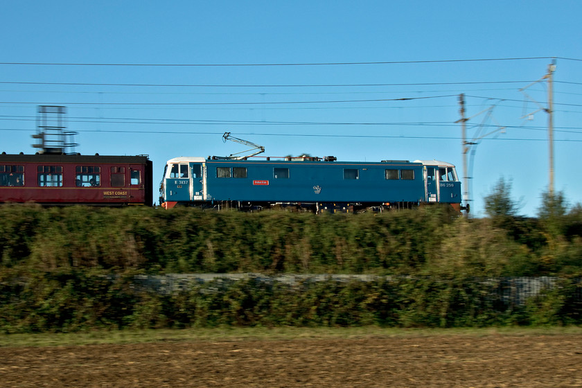 86259, outward leg of The Cumbrian Coast Express, 07.12 London Euston-Carlisle (1Z86, RT), Milton Crossing 
 As it usually does, 86259 'Peter Pan/Les Ross' looks superb, ably helped by the bright autumnal sunshine at Milton Crossing just north of Roade cutting. It is seen heading north leading the outward leg of 'The Cumbrian Coast Express' that left Euston at 07.12 and arriving at the right time at Carlisle. From there, ex-Southern Railway Merchant Navy Class 35018 'British India Line' took the train around the glorious Cumbrian Coast line. 
 Keywords: 86259 The Cumbrian Coast Express 07.12 London Euston-Carlisle 1Z86 Milton Crossing Les Ross Peter Pan