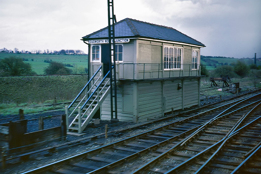 Cudworth North Junction Signal Box (Mid, date not known) 
 A somewhat blurred photograph of Cudworth North Junction signal box taken as we rattle past on our West Wilts Scout Special to York. The Midland signal box has been re-roofed with the finials not being reinstated and it appears to have had some windows blanked off giving it a slightly unbalanced and odd look. The line curving off behind the box led to Stairfoot Junction just to the east of Barnsley and, along with the Midland route that we are traversing, is long closed with part of the thirty-two mile Dearne Way taking the trackbed. 
 Keywords: Cudworth North Junction Signal Box