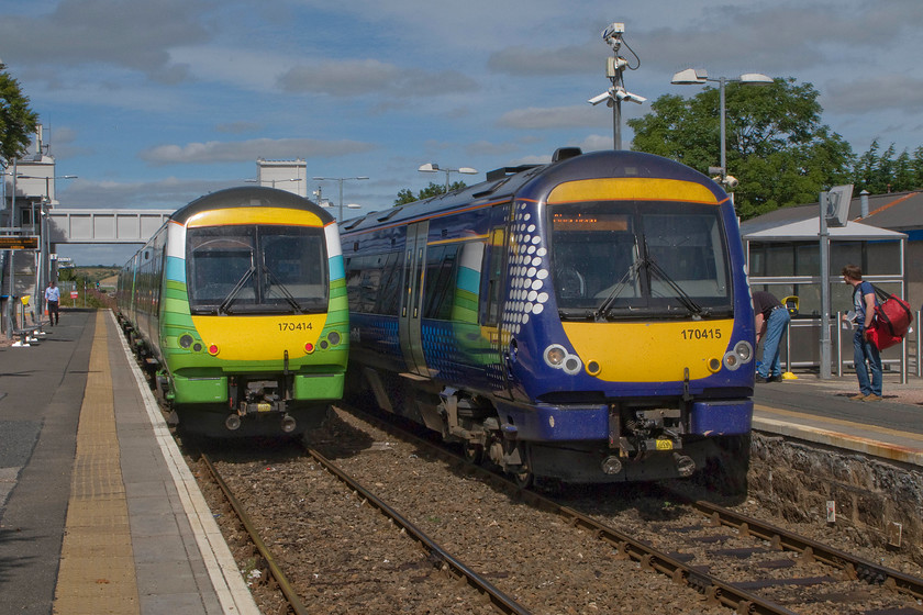 170414, SR 12.50 Aberdeen-Inverurie (2A52) & 170415, SR 10.57 Inverness-Aberdeen (1A50), Dyce station 
 With 170415 having just arrived at Dyce station with the 10.57 Inverness to Aberdeen service the single line section to Invuruie is now clear for 170414 to depart with the 2A52 12.50 from Aberdeen. The latter service will terminate at Inverurie. When I last visited this station it was ten years ago and on a wet and windy November night, after arriving at the adjacent airport on a heavily delayed flight from Luton. This was before the station had been rebuilt and it was a particularly inhospitable place but we found solace in the nearby Spider's Web bar whilst waiting for the last train north alighting very late at Forres! 
 Keywords: 170414 12.50 Aberdeen-Inverurie 2A52 170415 10.57 Inverness-Aberdeen 1A50 Dyce station ScotRail