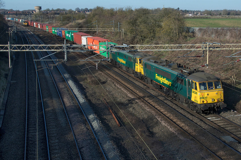 86632 & 86604, 05.00 Trafford Park-Felixstowe North (4L75, 1E), Victoria bridge 
 The 4L75 Trafford Park to Felixstowe Freightliner passes Victoria bridge on a glorious winter's day hauled by 86632 and 86604. The use of these veteran Class 86s continues some fifty-five years after their introduction but with increasing unreliability and the difficulty of maintaining them their time must surely be up very soon? Dating from April 1966 86632 leads the slightly older 86604 that entered service in the summer of 1965. 
 Keywords: 86632 86604 05.00 Trafford Park-Felixstowe North 4L75 Victoria bridge