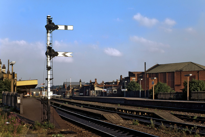 Lincoln St. Marks station looking east 
 Lincoln St. Marks station looks quiet in this early evening photograph looking east towards the town's High Street. As can be seen here, the station only had two platforms with two former centre passing lines that were truncated at just before the level crossing with the aforementioned High Street. These two stubs of track were used for light DMU and stock servicing hence the raised wooden platforms for staff to access the units. Signalling was controlled by a Midland box located a short distance behind me with a gatekeeper operating the barriers at the other end at the High Street. The station was opened by the Midland Railway in 1846 as the town's first station simply named Lincoln, the suffix of St. Marks was applied surprisingly late by British Railways in 1950. BR undertook a huge rationalisation of its operations in Lincoln a few years after this photograph was taken with the closure of the through route, along with St. Marks station coming in May 1985. The site lay derelict for a number of years until be turned into a shopping centre. 
 Keywords: Lincoln St. Marks station