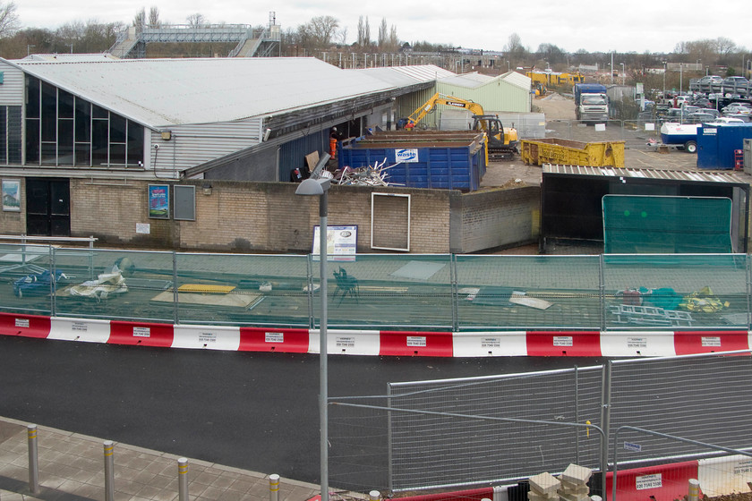 Demolition of old Northampton station 
 With the new station at Northampton having opened two weeks previously, demolition has begun of the old station. Seen from the elevated concourse of the new structure, the 1966 built station below looks as though it will not have long to stand. Note the extremely high temporary footbridge in the background built during the construction phase of the new station. 
 Keywords: Demolition of old Northampton station