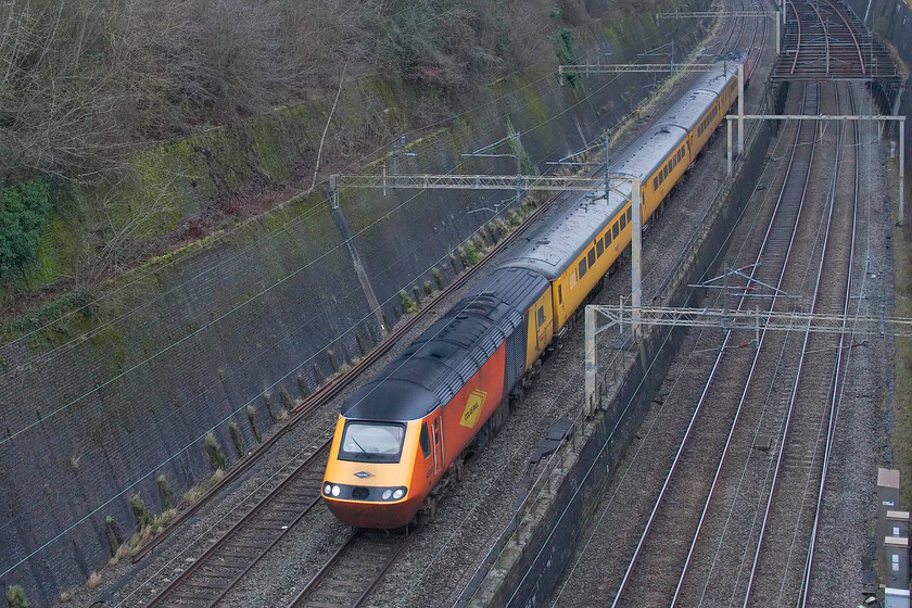 43257 & 43277, 11.37 Crewe Pottery Sidings-Derby RTC (1Q85, 1E), Roade cutting 
 Operated by Colas' 43257 leads the 11.37 Crewe Pottery Sidings to Derby RTC via a run along the WCML to Euston, passes through Roade cutting with 43277 'Safety Task Force' on the rear. It is unusual for a NMT to operate on a Saturday but due to the Christmas and New Year break affecting the normal programme of operations Network Rail has had to alter their normal working pattern of track monitoring. 
 Keywords: 43257 43277 11.37 Crewe Pottery Sidings-Derby RTC 1Q85 Roade cutting HST NMT Colas Safety Task Force