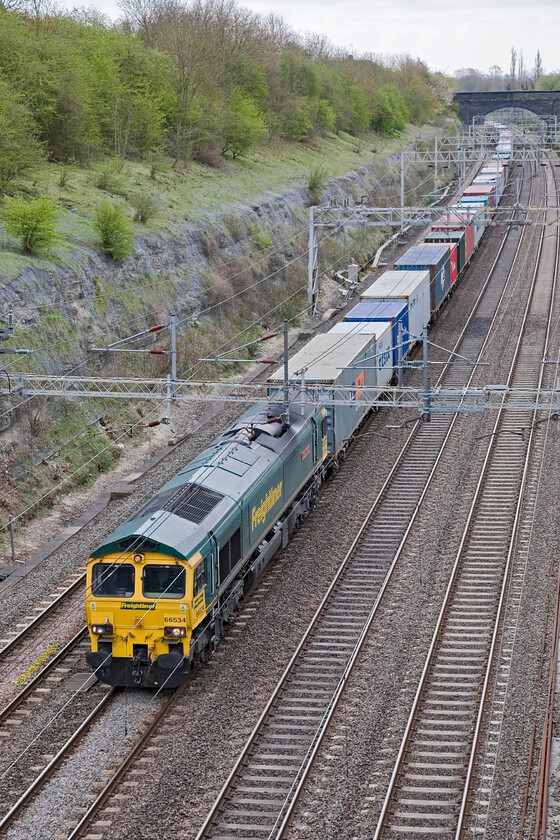 66534, 07.34 Felixstowe North-Lawley Street (4M94), Roade cutting 
 A well-loaded 4M94 07.34 Felixstowe to Lawley Street passes through Roade cutting led by Freightliner's 66534 'OOCL Express'. I have several images of this particular Class 66 all taken relatively local to my home here in Roade. 
 Keywords: 66534 07.34 Felixstowe North-Lawley Street 4M94 Roade cutting OOCL Express